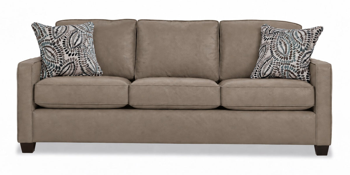 City Leather Sofa - Stone front view with three cushioned seats and backs, slim track arms, dark wood legs and two patterned accent pillows
