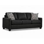 City Leather Sofa - Black in a three-quarter view with three seat cushions, slim track arms, dark wood legs and two patterned accent pillows