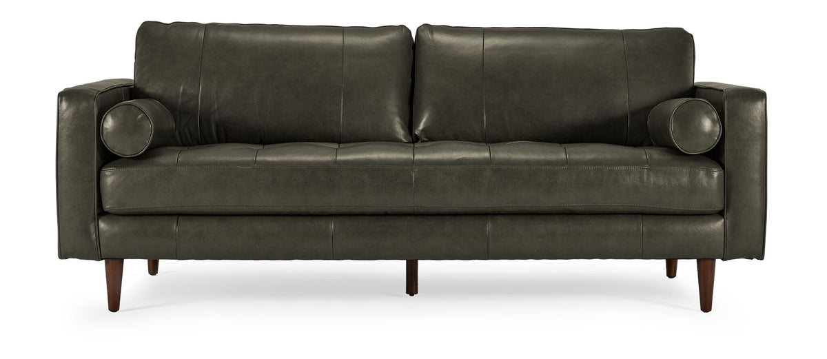 Front view of the Bari Leather Sofa in charcoal with two back cushions, tufted bench-style seat, cylindrical bolster pillows and wood legs