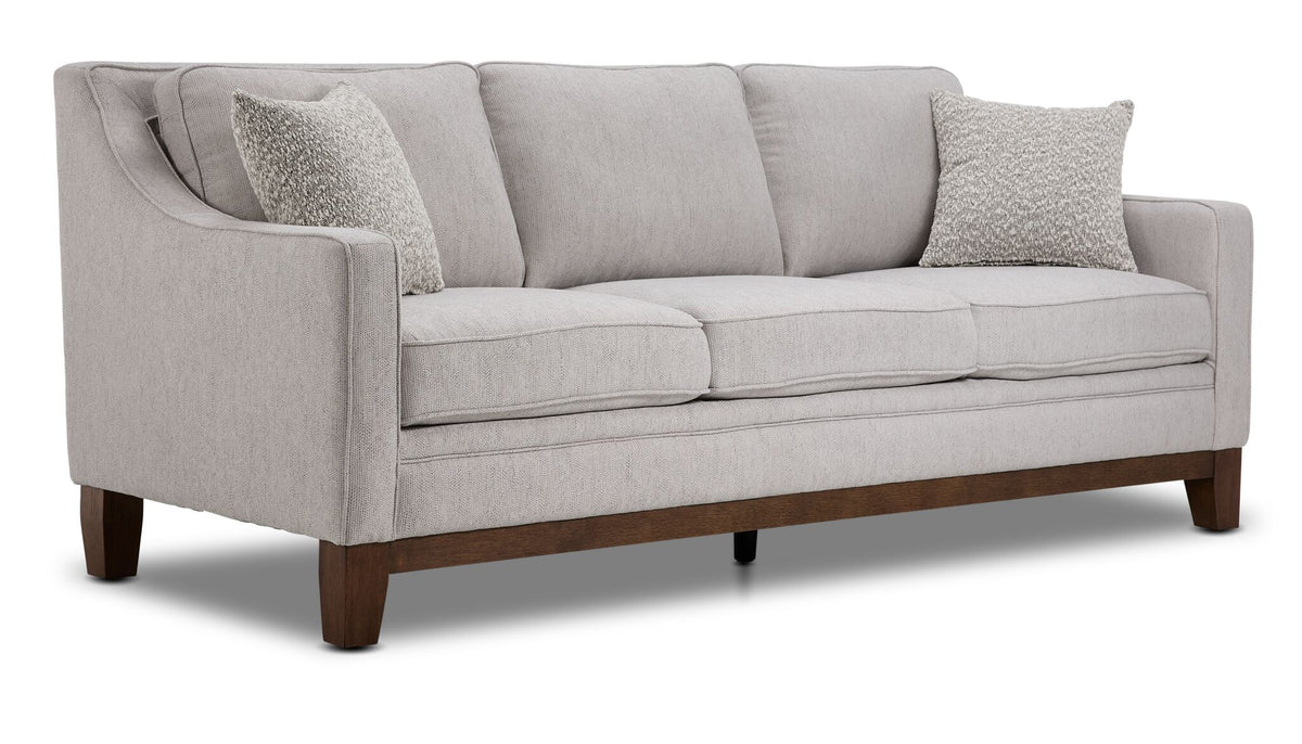 Lucerne grey sofa with three seat cushions, track arms, solid wood legs and angled front view