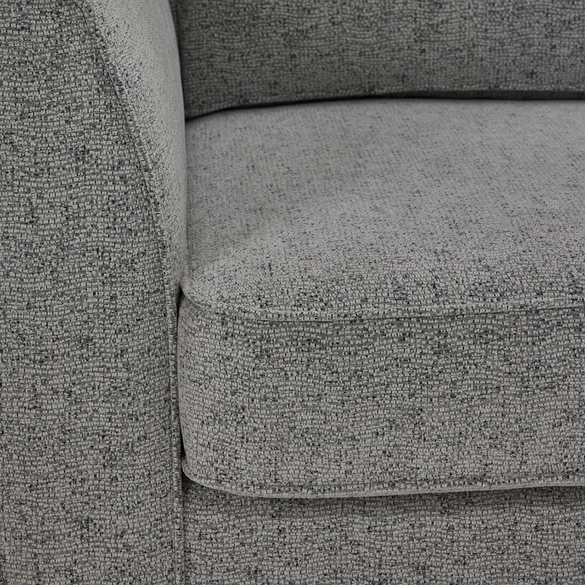 Moncton sofa close-up showing light grey polyester upholstery, cushion edge and seam detail