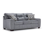 Mackay grey sofa with curved arms, three seat cushions, accent pillows and angled front view