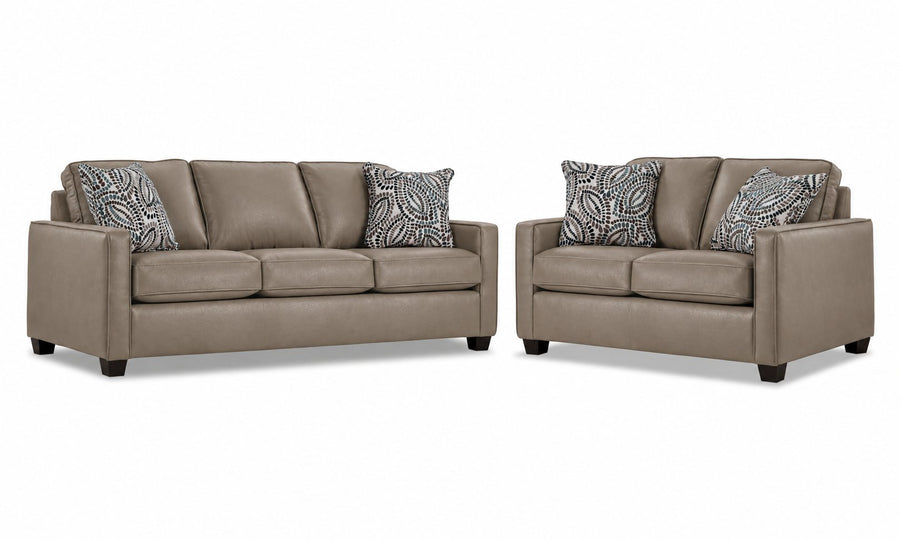 City Leather Sofa and Loveseat Set - Stone with matching leather seating, patterned accent pillows and dark wood legs