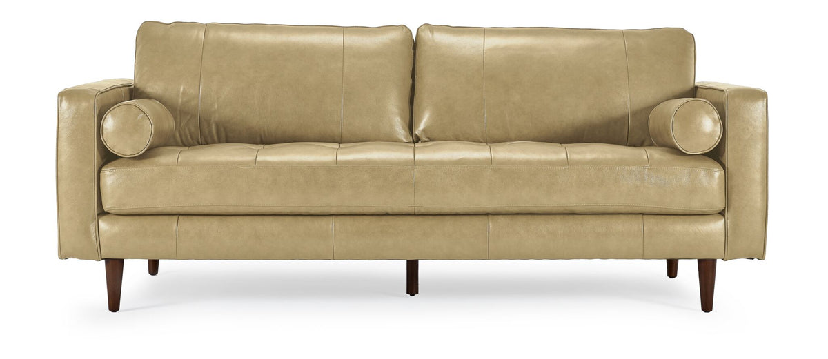 Front view of Bari Leather Sofa in stone with two back cushions, tufted bench seat, cylindrical bolster pillows and tapered wood legs