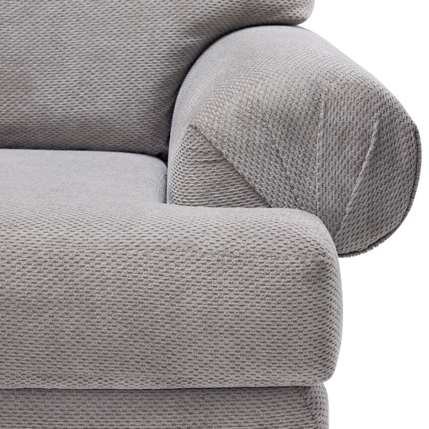 Jupiter Sectional - Ash Grey close-up showing textured upholstery, plush seat cushion and pleated rolled arm