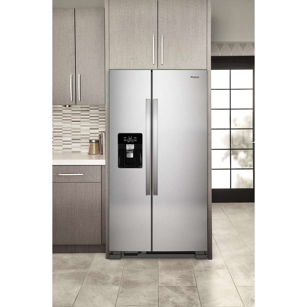 Whirlpool stainless steel side-by-side refrigerator in a modern kitchen with exterior ice and water dispenser