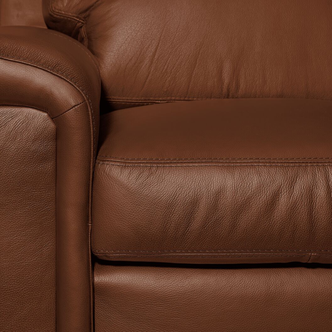 Icon Leather Sofa - Saddle close-up showing leather upholstery, stitching, padded arm and seat cushion